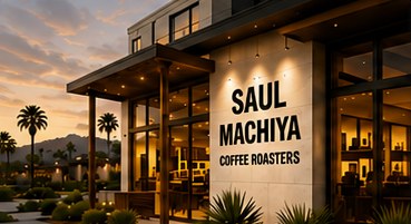 Local coffee shop storefront lit up at sunset